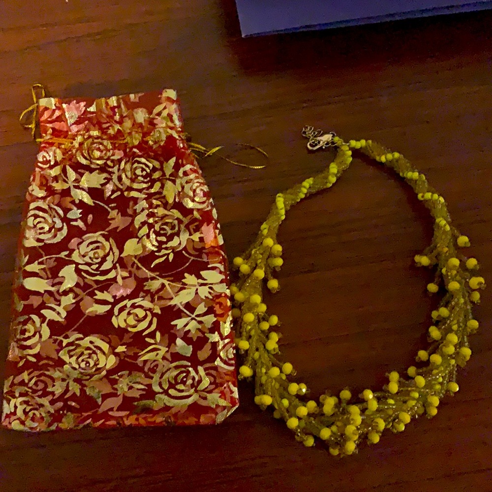 This is a well made yellow and honey colored necklace handmade